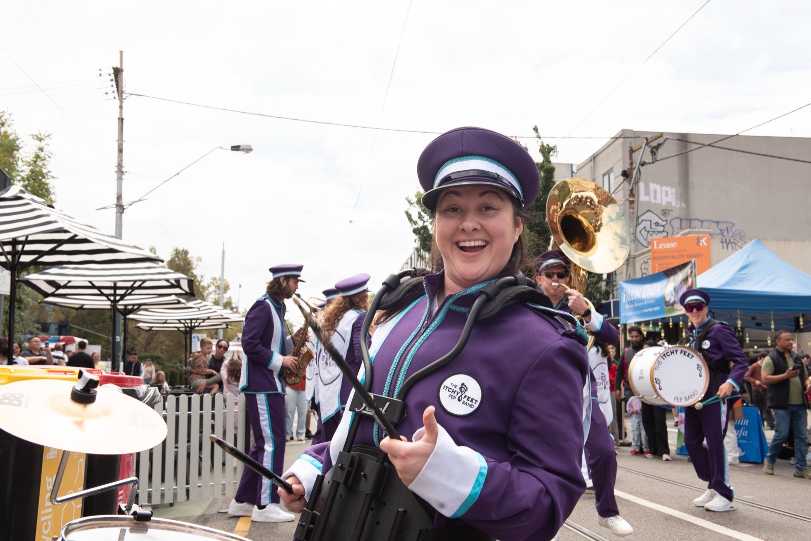 A smiling marching band leader in uniform