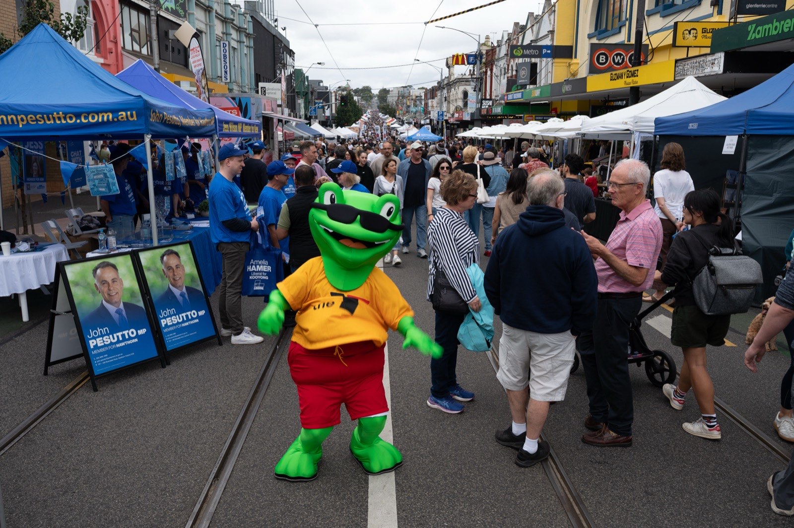 A mascot working the crowd along Glenferrie Road