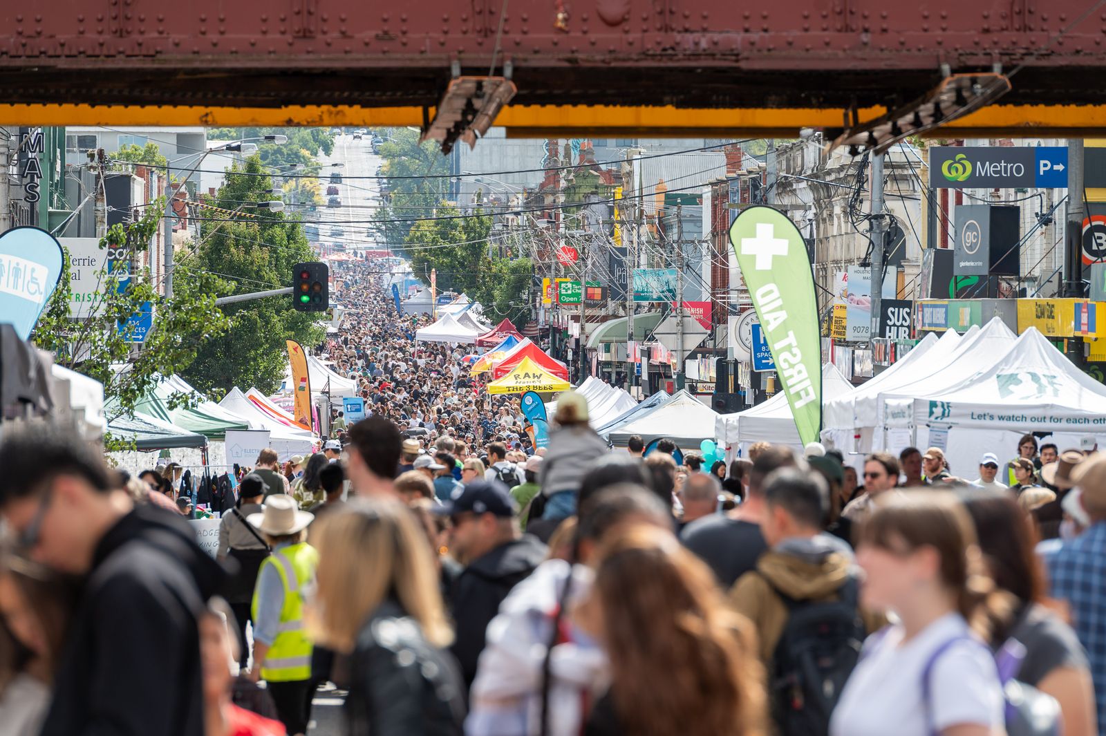 Festival crowds filling Glenferrie Road beneath the railway bridge