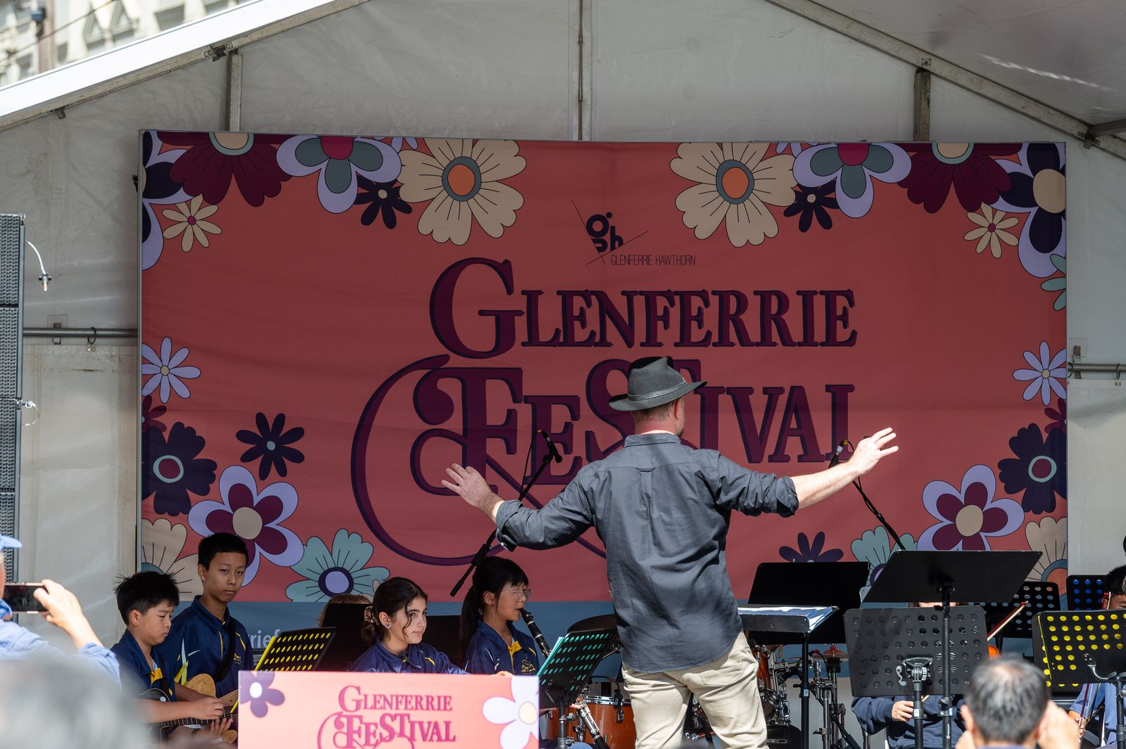 A band performing in front of the Glenferrie Festival main stage sign