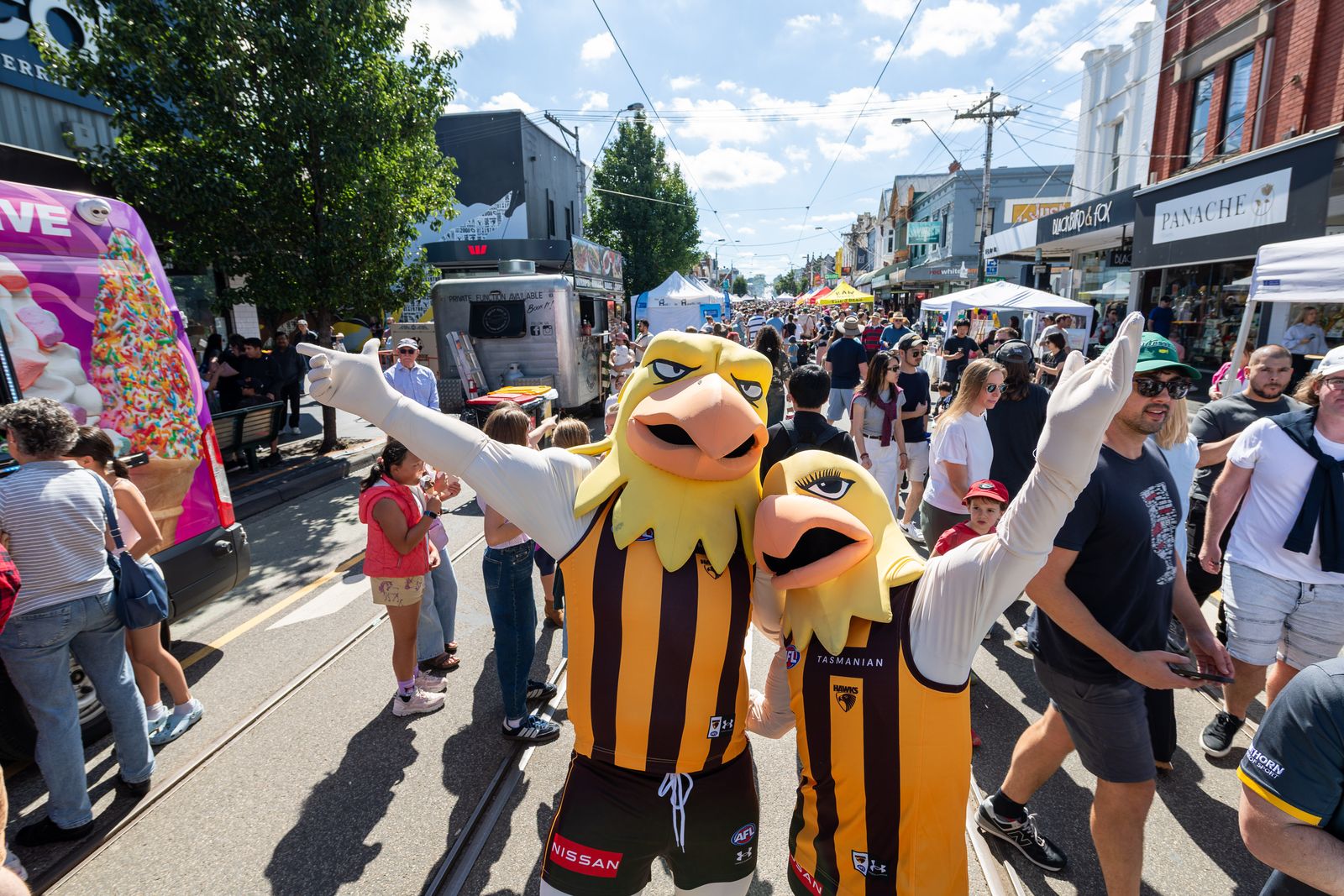 Hawthorn Hawks mascots greeting the crowd on Glenferrie Road