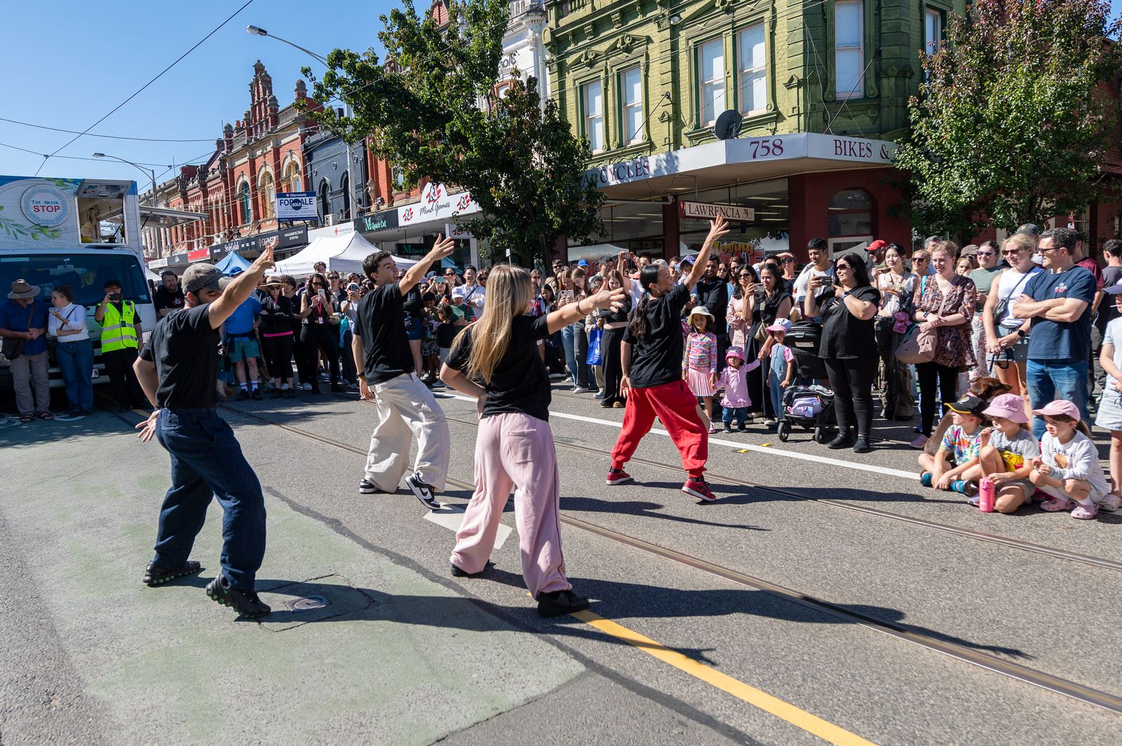 Flash mob dancers performing for the crowd on the street