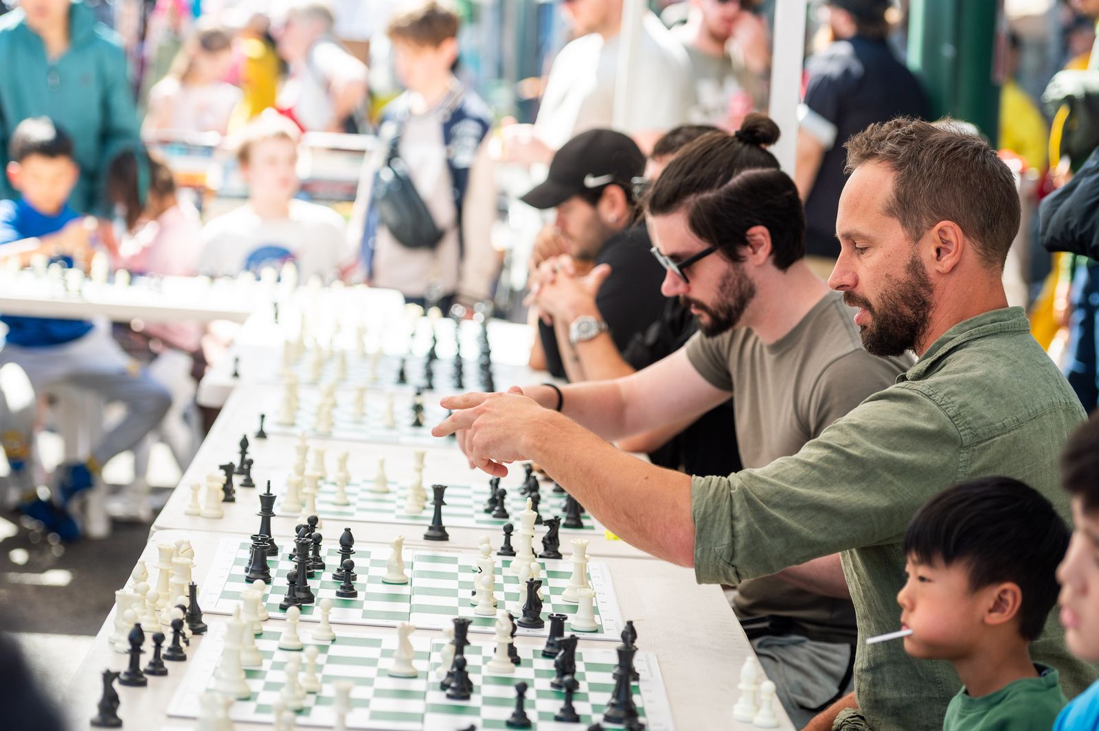 Festival-goers playing giant chess on the street