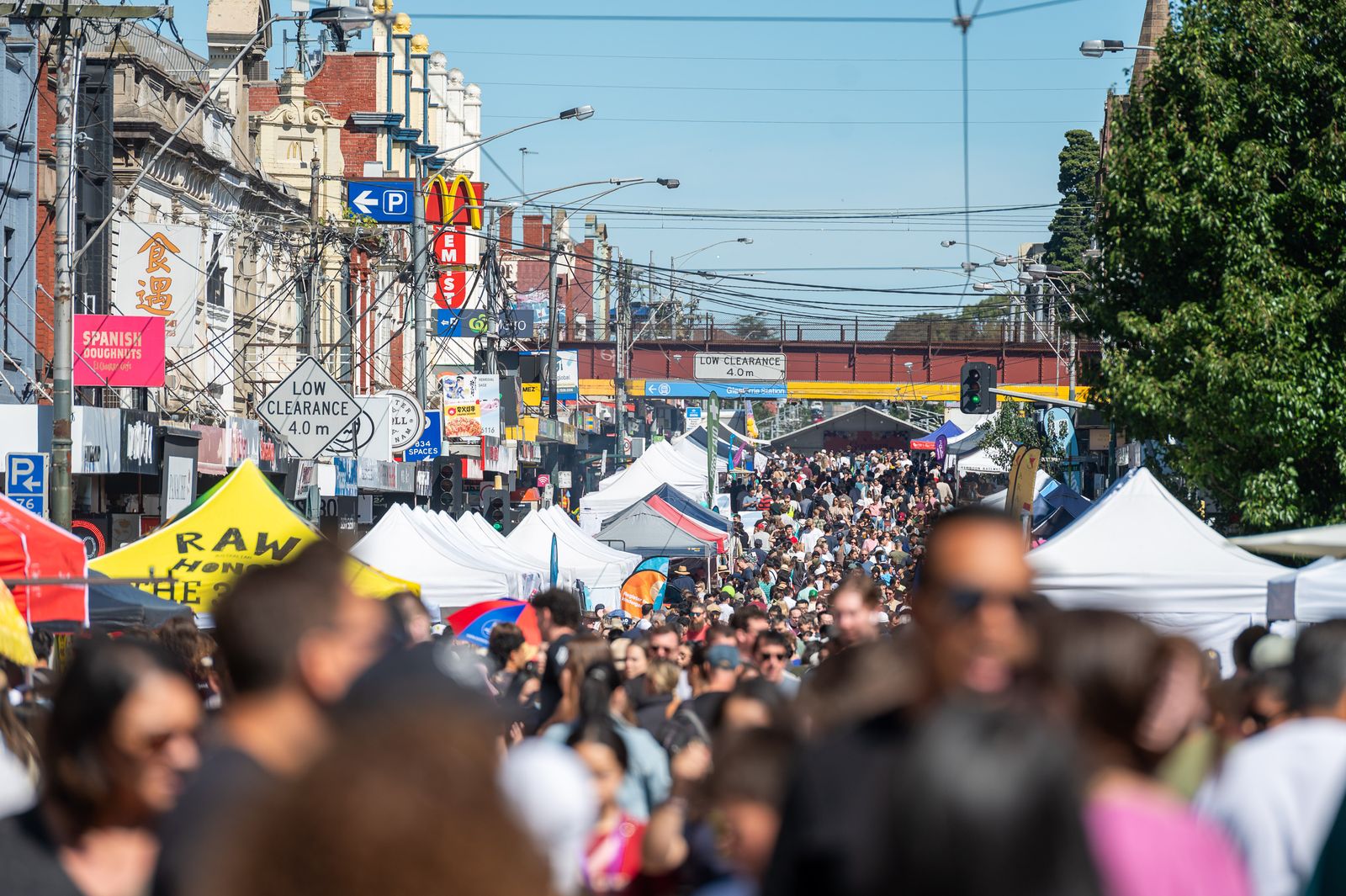 Crowds browsing the market stalls along Glenferrie Road